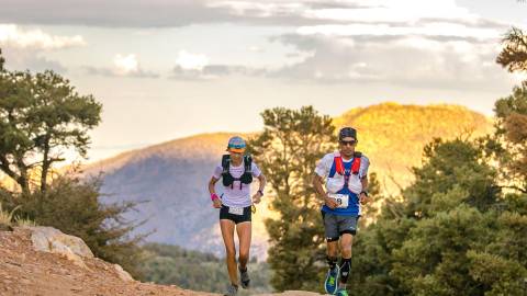 Two runners jog up a trail during the Kodiak 100 race in Big Bear Lake.