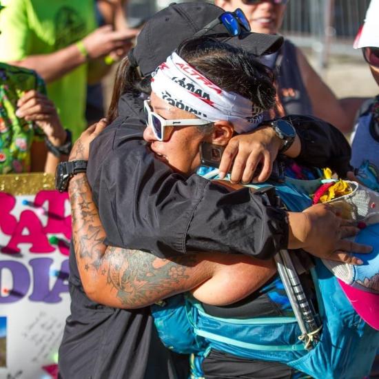 two people hug at the Kodiak 100 finish line in Big Bear