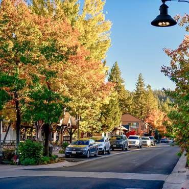 Big Bear Lake's Village during Autumn - the fall colored leaves seen on trees along the sides of the Village's main street.