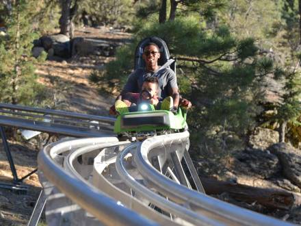 A father rides the Mineshaft Coaster with his daughter in Big Bear, California.