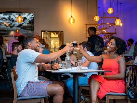 "A couple enjoying a meal together and raising their glasses in a toast at Stella Luna Restaurant in Big Bear"