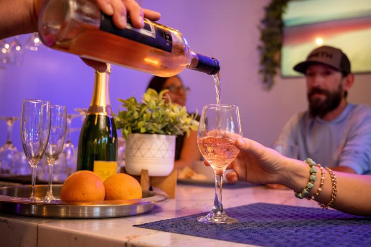 A bar tender pours a glass of wine for a customer at Stella Luna Restaurant in Big Bear Lake, CA.