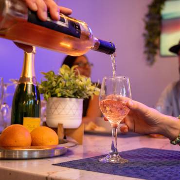 A bar tender pours a glass of wine for a customer at Stella Luna Restaurant in Big Bear Lake, CA.