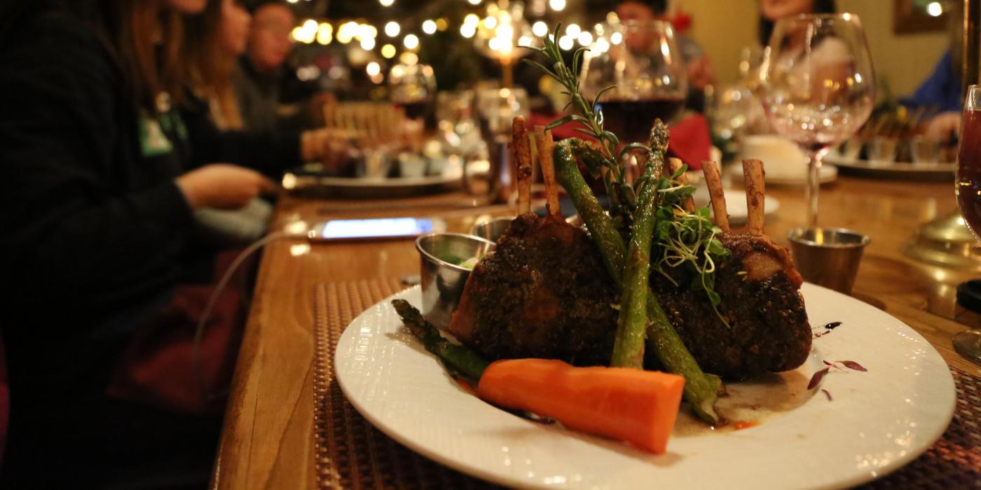 A steak sits on a plat with a carrot and asparagus at a fine dining restaurant in Big Bear Lake, CA.