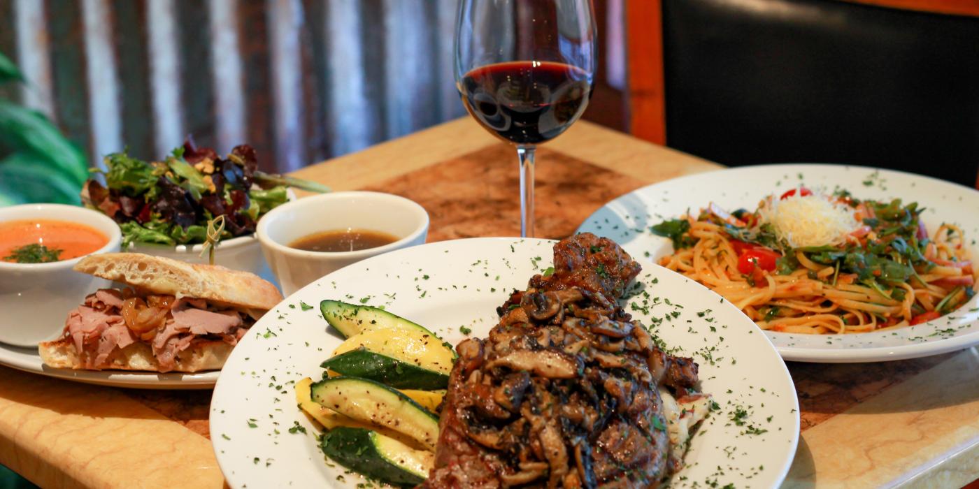 A photo of Sweet Basil Bistro's fine dining options, the dishes shown are steak, pasta, and a sandwich with tomato soup