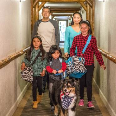A family walks down a hallway of a Big Bear Lake hotel.