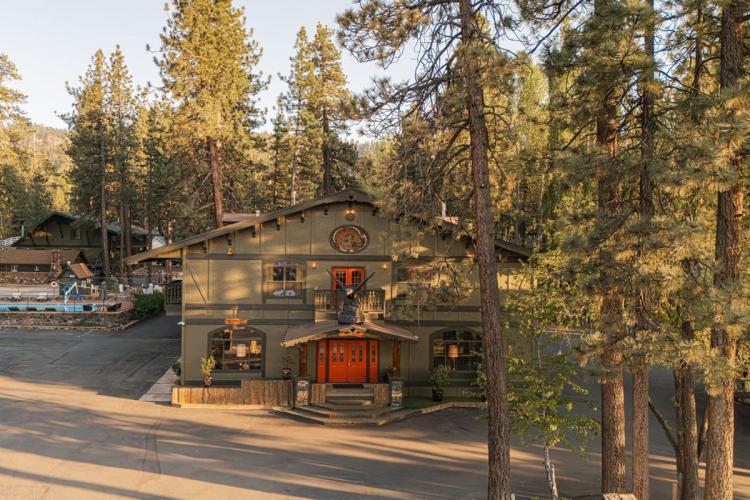 An aerial drone view of Sessions Retreat & Hotel's entrance - there is a giant eagle statue above the doorway's roof.