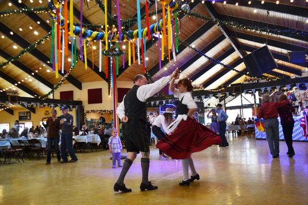 A male and female in traditional maifest outfits dancing at Wyatt's